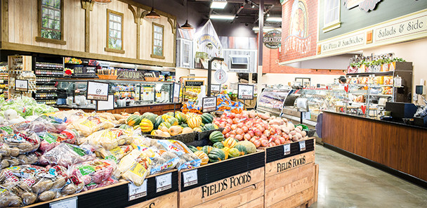 Interior of grocery store with bins of fresh produce.
